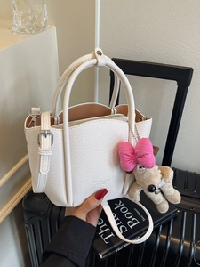 Minimalist white litchi pattern leather handbag with cute plush dog pendant and strap
