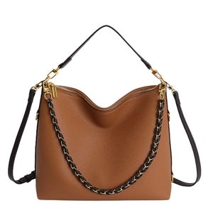 Detailed view of brown litchi grain leather tote with chic black gold braided chain strap