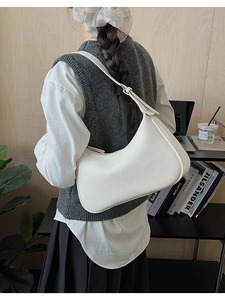 Detail shot of a minimalist cream hobo bag made from premium lychee textured leather