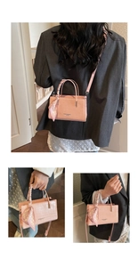 Pink croc-embossed handbag featuring a silk scarf handle and adjustable shoulder strap