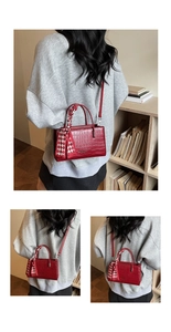 Detailed close-up of red crocodile pattern texture handbag with elegant silk scarf handle