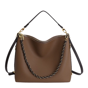 Brown lychee leather tote bag with woven chain strap and gold hardware on white background