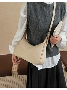 Chic beige grain leather hobo bag styled with casual outfit for a modern daily look