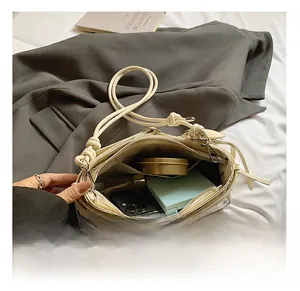 Interior view of off-white polka dot shoulder bag showing space for phone and makeup