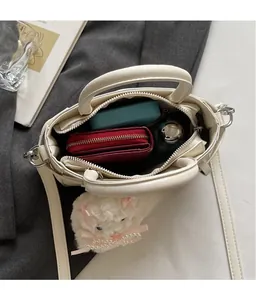Top view of cream white crossbody bag interior showing spacious storage for daily items