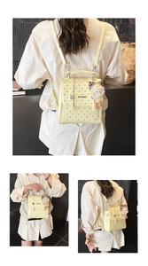 Detailed view of yellow polka dot mini backpack with cute plush charm and versatile straps