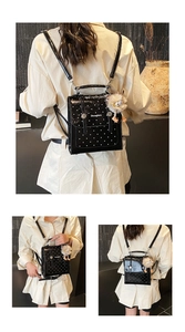 Close-up of mini black polka dot backpack with plush monster keychain and metal buckle