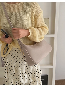 Close-up of litchi grain leather shoulder bag with zipper and comfortable strap