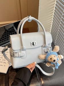 Light blue faux leather handbag with silver twist lock and cute teddy bear charm