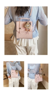 Detail of pink polka dot mini backpack with cute cat ear plush charm and crossbody strap