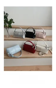 Detailed row of stylish leather handbags in six colors with circular metal ring hardware