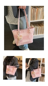 Detailed view of pink plaid tote bag with plush bear charm and spacious PU leather design