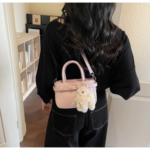 Borsa a mano rosa in ecopelle con ciondolo a coniglio bianco e tracolla regolabile