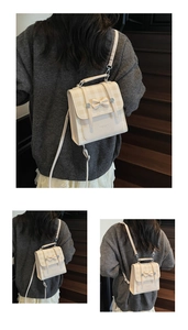 Detail of cream checkered mini backpack with decorative bow and silver metal studs