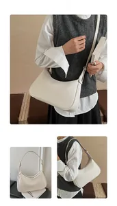 Detailed view of a white lychee grain leather hobo bag with adjustable strap and silver hardware