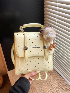 Cute cream polka dot mini backpack with plush charm and convertible straps for women