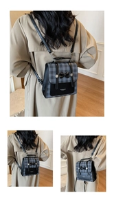 Detail of grey plaid and black leather backpack with bow accent and silver metal buckle