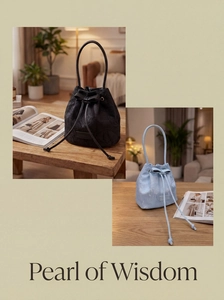 Detail of drawstring bucket bags with floral embossing and bow accents in black and blue