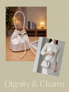 Detail of white bucket bag with floral jacquard texture and leather bow decoration