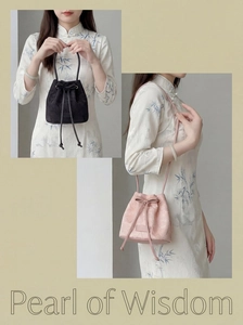 Detail of New Chinese bucket bags with floral embroidery and bow drawstring closure