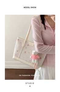 Close-up of cute canvas tote bag with pink bunny patterns and bear plush charm