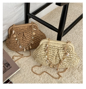 Detail of woven straw bags with shell charms and gold chain straps for beach vacations