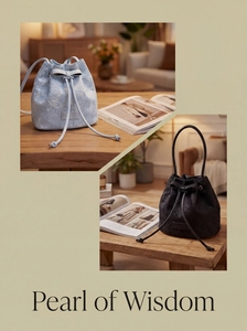 Detail of embroidered lace bucket bags with bow drawstring and textured floral pattern