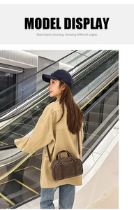 City street view of model carrying dark brown matte Boston bag in cross-body style