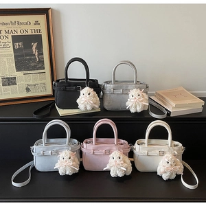 Mini PU leather crossbody bags in five colors with cute plush bunny charms on display
