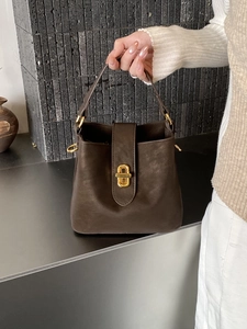 Chic dark brown lychee textured leather bucket bag with gold twist lock and top handle