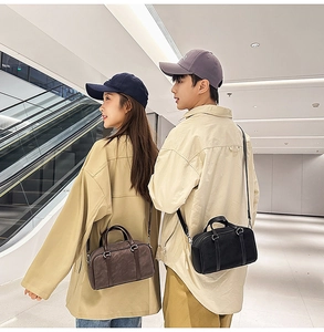 Close-up of vintage mini Boston bags in coffee and black colors with dual top handles