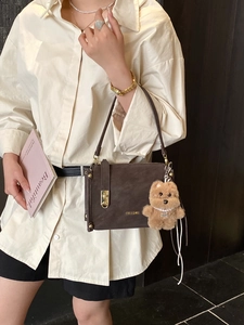 Classic dark brown matte shoulder bag with a bear pendant and vintage lock detail