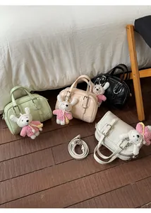 Detail showing various colors of leather Boston bags with cute teddy bear pendants