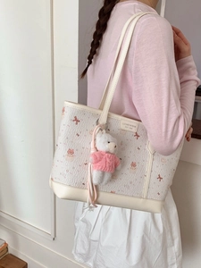 Creamy white large tote bag with cute cartoon bear prints and a plush teddy bear charm