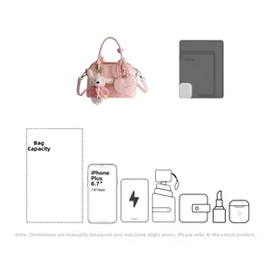 Pink shell handbag showing interior capacity with plush bunny charm and shoulder strap