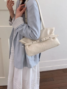 Chic cream white tote bag with pleated texture and buckle strap for spring fashion