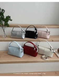 Multiple vintage women’s handbags in various colors displayed on a wooden staircase