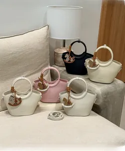 Three leather bucket bags with round handles and wooden horse charms in a cozy setting