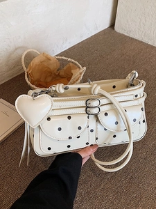 Chic cream-white polka dot underarm bag with double buckle pockets and heart charm