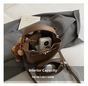 Interior view of brown leather bucket bag showing large storage capacity and wallet