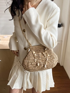 Woven straw beach bag with shells and pearls decoration and gold chain strap