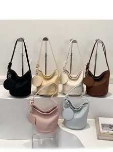 Minimalist bucket bags in six colors with pebble leather and matching coin purses