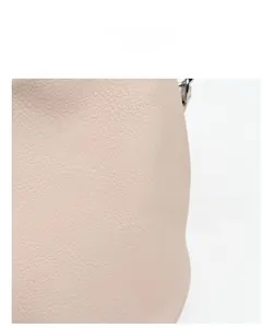 Macro detail of soft lychee pattern leather texture on a beige shoulder bag