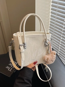 Chic off-white bucket bag with marble texture and cute teddy bear charm for women