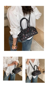 Detail of cherry and floral print on black oxford cloth versatile shoulder bag