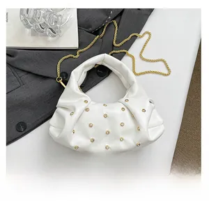 Detailed view of white pleated rivet handbag with rhinestones and chain strap size comparison