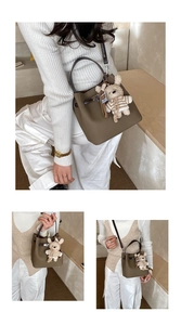 Deep camel lychee leather bucket bag shown in handheld, crossbody and shoulder styles