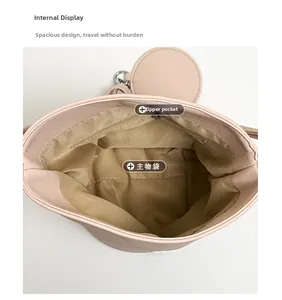 Detailed interior view of pink bucket bag showing large capacity and zipper pocket