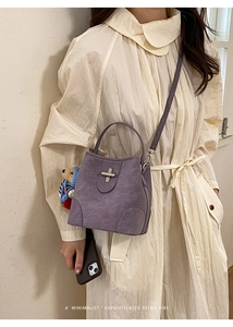 Chic purple retro bucket bag with metal clasp and cute teddy bear charm detail