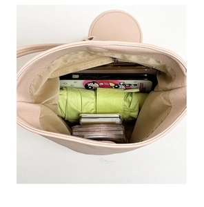 Top view of pink bucket bag showing large capacity with internal zipper pocket